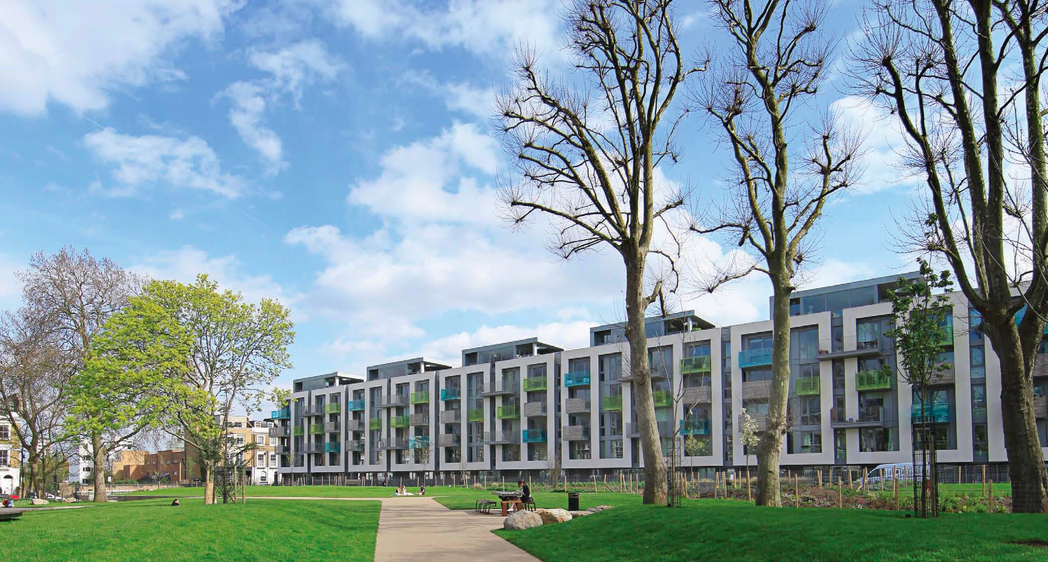 Arundel Square, Islington N7: completed 5-storey crescent apartment block with sawtooth roof profile, viewed from the residents' park